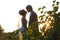 Gentle couple holding hands on background leaves and sunset