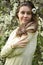 Gentle female portrait with the blooming cherry-trees