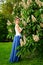 Gentle female portrait in the blooming garden in the spring.