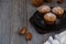 Gentle and fragrant mafins with frozen plum on a black plate on the old wooden table