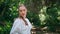 Gentle girl walking park at greenery summer day close up. Woman strolling forest