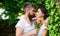 Gentle kiss. Man bearded hipster hugs gorgeous girlfriend. Pleasant romantic kiss. Couple love romantic date nature park