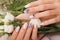 Gentle neat manicure on female hands on flowers background. Nail design