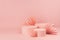 Gentle pastel pink abstract stage mockup with group of three round podiums, paper hearts of asian fans in chinese style.