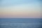 Gentle pastel sunset over the calm surface of the sea