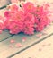 Gentle pink roses on wooden table