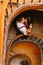 Gentle, sensual, sweet, passionate couple softly kissing on the background of vintage marble stairs in Lviv. View from