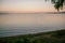 Gentle soft light pink dawn on the big lake, sunrise