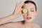 Gentle sophisticated calm girl in a moisturizing mask with a fresh cucumber