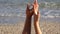 Gentle touch, lovers hands playing, finger touch, close up, beach, sea waving