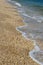 Gentle waves lapping on a pebble sand beach