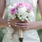 Gentle wedding bouquet of flowers in hands bride