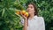Gentle woman posing oranges at greenery nature portrait. Girl looking camera