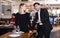 Gentleman helping woman with her chair in restaurant