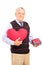 Gentleman holding a heart shaped object and gift