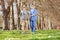 Gentleman and a male nurse walking in park