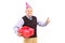 A gentleman with party hat holding a gift and giving a thumb up