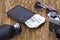 Gentlemanly set: sunglasses, perfume, wallet, money,camera on wooden background