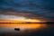 Gently blurred small boat rocking in bay at sunrise