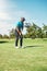 Gently now. a focused young male golfer about to play a shot with his putter on a golf course outside during the day.