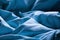 Gently sleeping blue bed sheet in soft morning or evening romantic sunlight as beautiful textile sleep relaxation decorative back