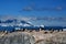 Gentoo penguins - Pygoscelis papua - on rocks in front of Southern Ocean with icebergs and mountains at Cuverville, Antarctica