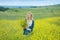 Genuine cute lady woman in meadow of yellow flowers sniffing flower bouquet. Attractive beautiful young girl enjoying the warm sum