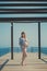 Genuine cute pregnant lady woman in jeans shirt posing beach wooden palette bridge holding tummy abdomen dreaming. Attractive beau