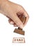 Genuine fake, rubber stamp. My hand with rubber stamp isolated on white. Business, politics or trade ethical concept.