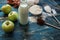 Genuine ingredients for the cake - apple, milk, flour, eggs and cacao on blue rustic table
