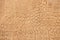 Genuine leather texture with imitation of exotic reptile, brown matte surface, trendy background. Ideal for clothing