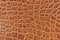 Genuine leather texture with imitation of exotic reptile, light orange brown matte surface, trendy background