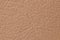 Genuine plain beige leather as background macro photo