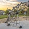 Geodesic dome climber against homes and cloudy sky