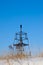 Geodesic sign on a background of a blue sky in winter. vertical