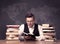 Geography teacher at desk with pile of books