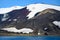 Geologic layers on volcanic mountains of Deception Island, Antarctica. Small sunken tanks of abandoned whale station, Lost places,