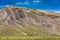 Geological rock formation behind settlement on trek to Rainbow Mountain, Peru.