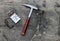 Geologists compass on the stones with hammer. Geology science concept. The geologist's hammer and tools are laid out on