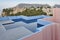 Geometric building swimming pool. Red wall, La manzanera. Spain