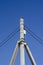 Geometric composition of concrete rectangular beams and electrical wires against a blue sky