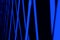 Geometric dark neon blue glowing cold light intersecting lines on a black background. tinted classic blue color trend 2020 year