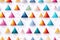 Geometric futuristic seamless pattern with multicolored triangle shapes on white background