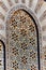 Geometric muslim mosaic in Islamic mosque, beautiful Arabic tile pattern and mosaic on the wall and doors of mosque in Casablanca