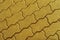 Geometric pattern made of square asphalt bricks in gold color