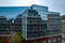 Geometric shapes of modern corporate building with mirrored glass wall and windows