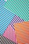 Geometric striped background. A modern, trendy multi-colored background made of sheets of striped paper lying in layers