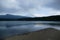 Geometric view with coast in the foreground and small hills and Mount Fuji in the background, Japan