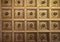 Geometrical squares with central decoration golden plaster ceiling from historical Palace in Caserta, Italy