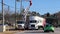 Georgia Power Utility workers on a lift working on power lines semi truck makes a tight turn expert driver